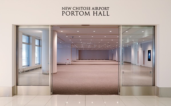 ホワイエホールの窓から見える、雪が積もった空港の風景