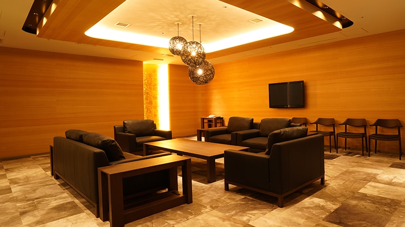 The interior of VIP rental room "Ezomatsu" is furnished with a sofa and table.